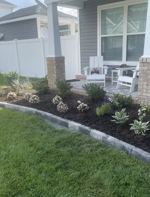 Front porch with flower bed and welcome sign